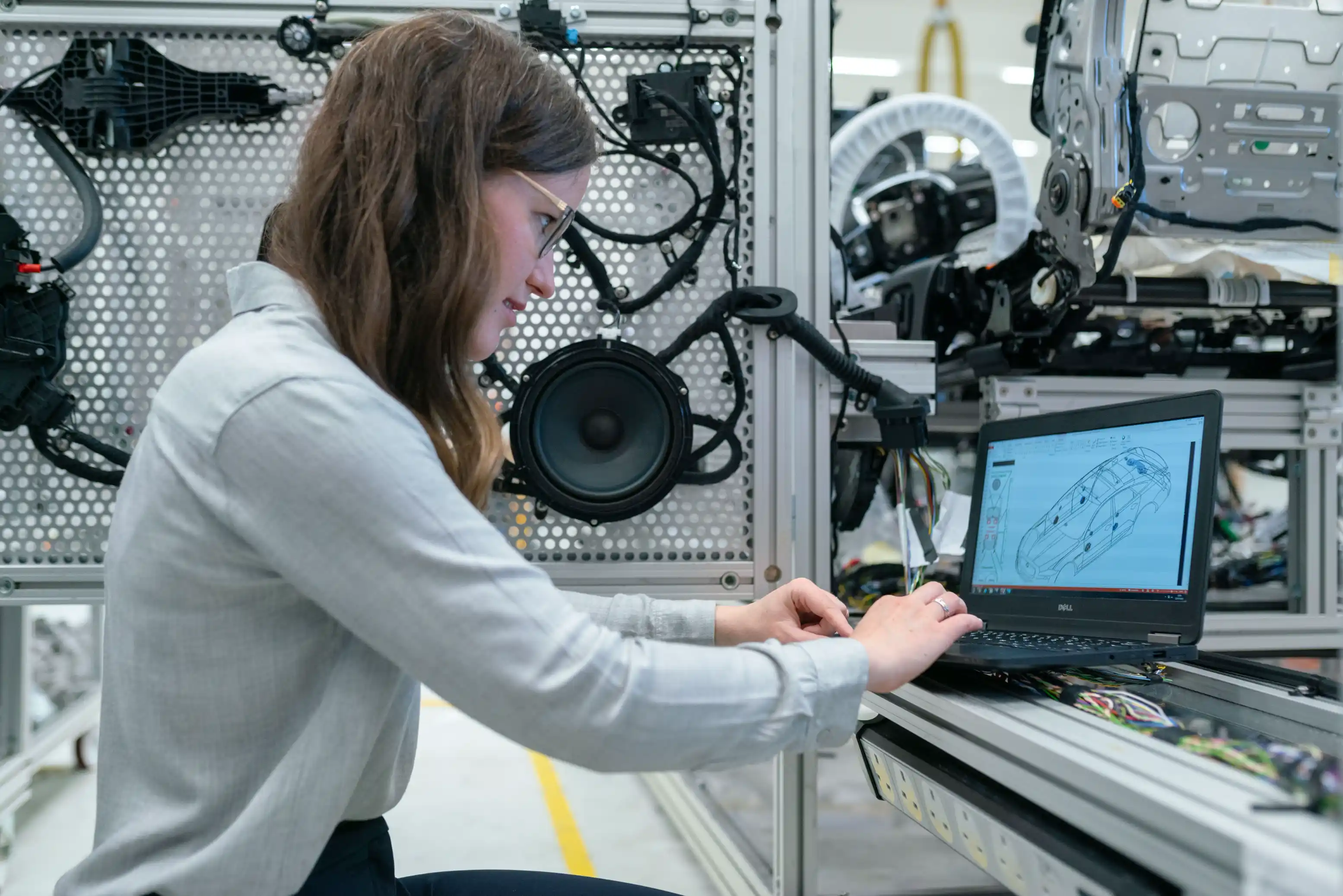Developer testing a hardware prototype beside a laptop during MVP development