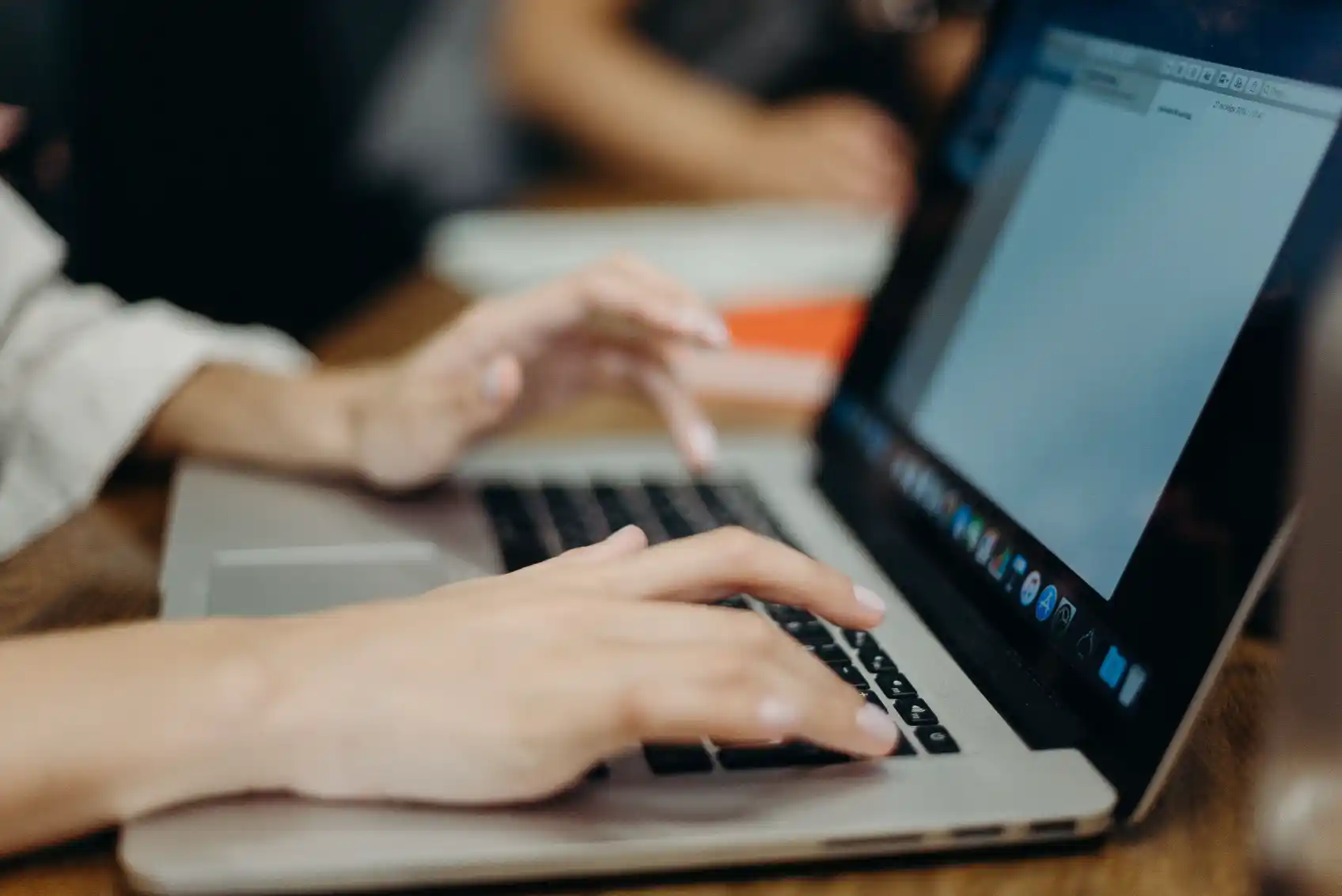 Person typing a prompt into ChatGPT on a laptop